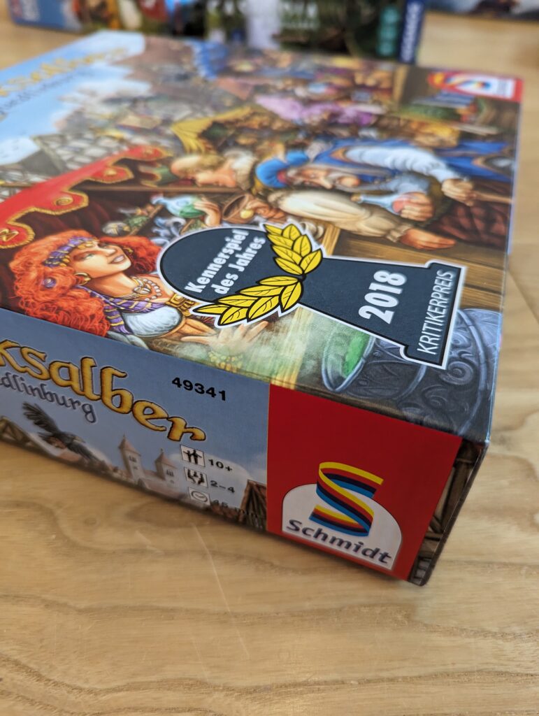Seitenansicht Spielebox die Quacksalber von Quedlinburg, Altersempfehlung 10+, 2 bis 4 Spieler, Spieldauer 45 Minuten